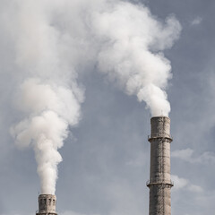 thick smoke from industrial pipes pollutes the air
