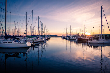 Fototapeta na wymiar Sailboats Docked in Marina During Sunset