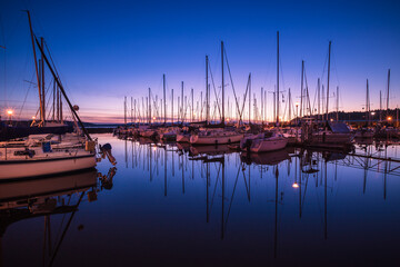 Sailboats with Reflection in Still Water at Marina During Blue Hour