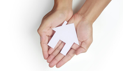 Hands holding paper house, family home protecting insurance concept