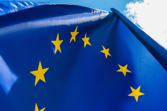 close up view of european union flag against sky