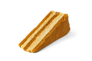 Slice of honey cake isolated on white background.