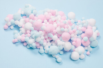 White, pink and blue soft pompons as a background.