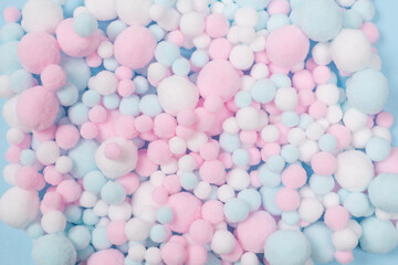 White, pink and blue soft pompons as a background.