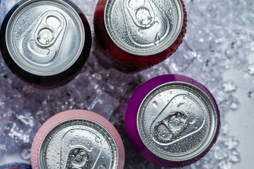 Group of aluminium cans in ice, cold drink.
