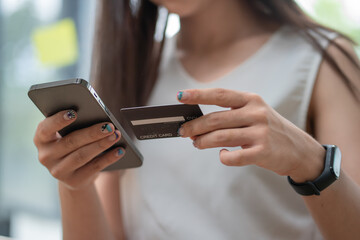 Hands holding credit card and using mobile smart phone with morning, Online shopping.