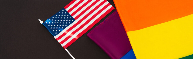high angle view of american and lgbt flags isolated on black, banner