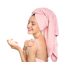 Young woman washing body with soap bar on white background