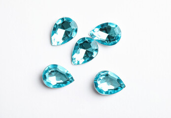 Beautiful gemstones on white background, top view