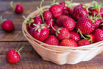 Strawberries with strawberry leaf in  wicker basket