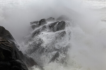 Stormy wave splash over big cliffs detail