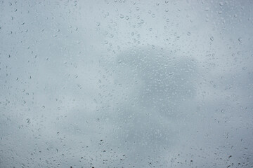 texture of bokeh drops on glass in front of sky