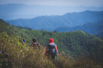 Fototapeta premium hiking group on mountain at Khao Chang Phueak, Thongphaphoom National Park, Kanchanaburi Province, Thailand. Subject is blurred, noise and color effect.