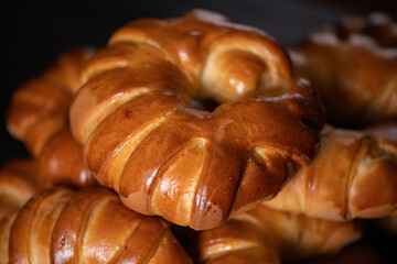 Delicious homemade buns on a dark background, close-up.