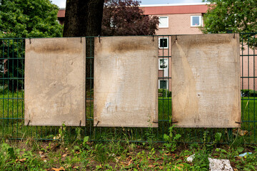 three blank or empty cardboard election poster fixed by zipties on fence, just blend in your...