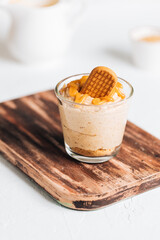 Caramel cheesecake in glass with biscuit 
