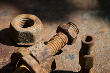 old rusty bolt, iron rod with screw threads. Rusted mechanical components. threaded bolt and nut. dismantling concept, difficult to unscrew, non-removable. selective focus, close-up, macro