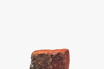 A Single Square Rock for a Product Display, Showing the Top Ledge and Front Face of the Block, with a Rough Spicy Texture Isolated on a White Background. 