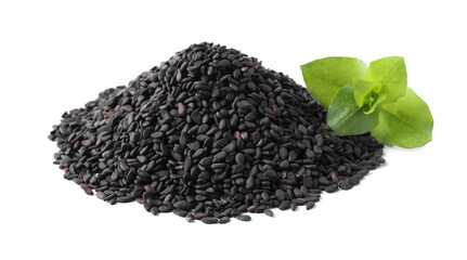 Pile of black sesame seeds with green leaf on white background