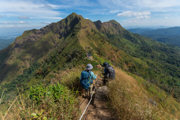 happy woman hiking on top mountain at Khao Chang Phuak, Thongphaphoom National Park, Kanchanaburi...