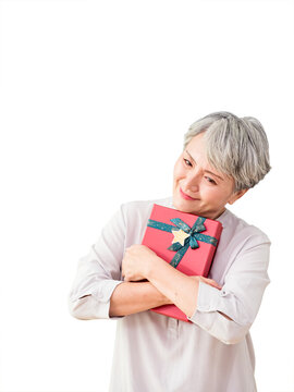 Senior asian woman holding gift over isolated background.