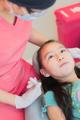 Girl in a dental office, receiving dental treatment.