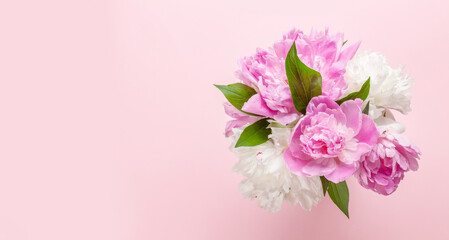 Fototapeta na wymiar Beautiful garden peony flowers bouquet on pink