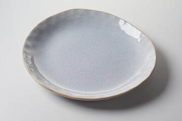 Handmade stylish pottery dish with irregular shape and surface