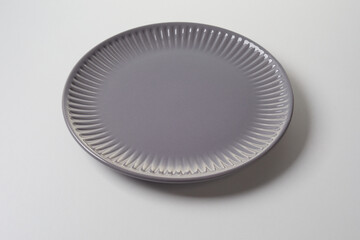 Stylish clean empty grey ceramic plate with fluted rim