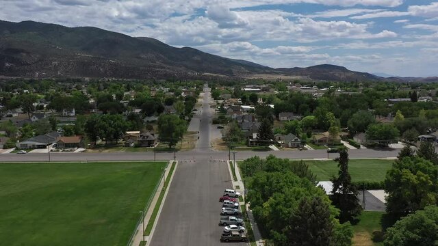 Aerial view flying over street in Manti Utah on summers day.