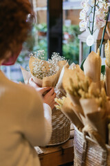 Hands of unrecognizable person in a flower shop.