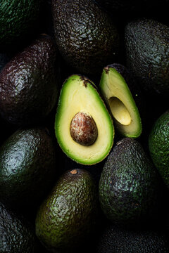 Avocados whole and sliced background pattern