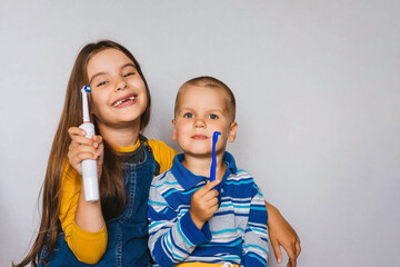 Children with toothbrushes in their hands. Medicine, dental hygiene concept.