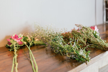 Flowers on a wooden table while preparing a bouquet.