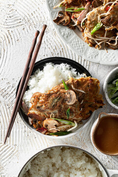 Egg Foo Young with Rice and chopsticks