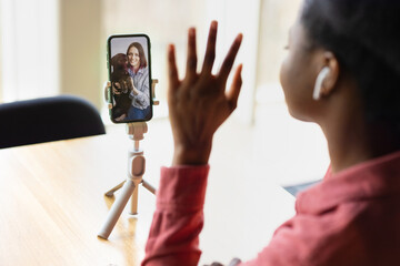 african american woman video chatting from her smartphone or watching live streaming, african woman studying online, millennial black woman internet dating and chatting online, modern confident afro