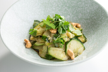 Delicious Chinese food spicy and sour cucumber salad with sesame seeds isolated on white background