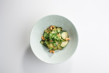 Delicious Chinese food spicy and sour cucumber salad with sesame seeds isolated on white background