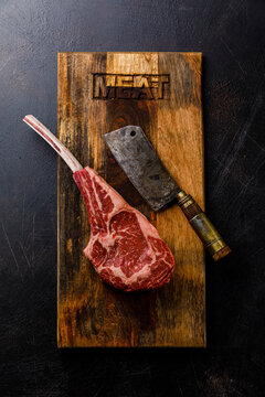 Raw Tomahawk Steak and butcher cleaver