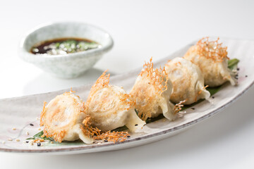 Ebi gedza hot dish soy sauce Japanese fried dumplings isolated on white background