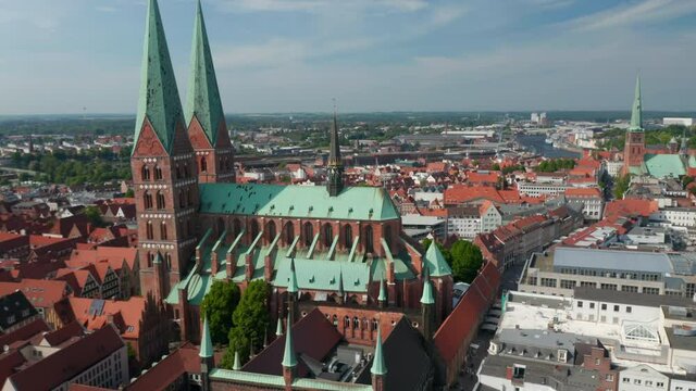 Aerial shot of historic city centre. Orbiting around brick gothic St. Marys Church. Luebeck, Schleswig-Holstein, Germany