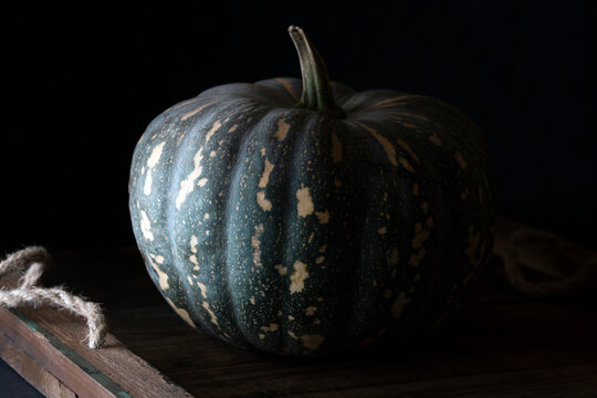 Jap pumpkin on a rustic wooden tray.