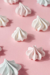 Pink and white meringue, zephyr, marshmallow, on pink background, selective focus