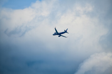 Fototapeta na wymiar the plane flies through the sky with clouds