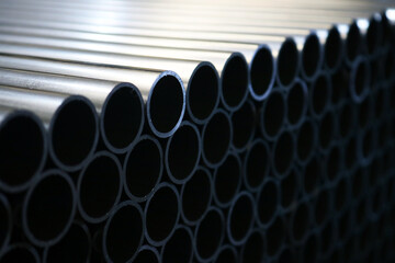 Galvanized steel round pipe background in dark light.	