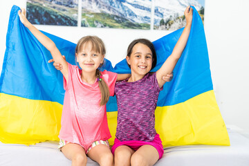 Fototapeta na wymiar two little girls with the flag of ukraine.