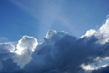 Fototapeta na wymiar Beautiful blue sky with large white clouds and sunrays.