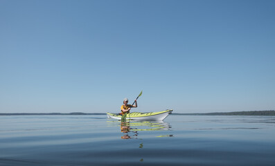 Kayaking in calm water on a sunny clear day