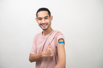 Portrait photo young happy Asian hipster man with colorful bandage feeling confident after received covid-19 vaccine from free vaccine campaign for prevent coronavirus outbreak. Asian people portrait.