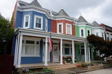 Fototapeta premium Colorful Row Houses with flowers and an american flag